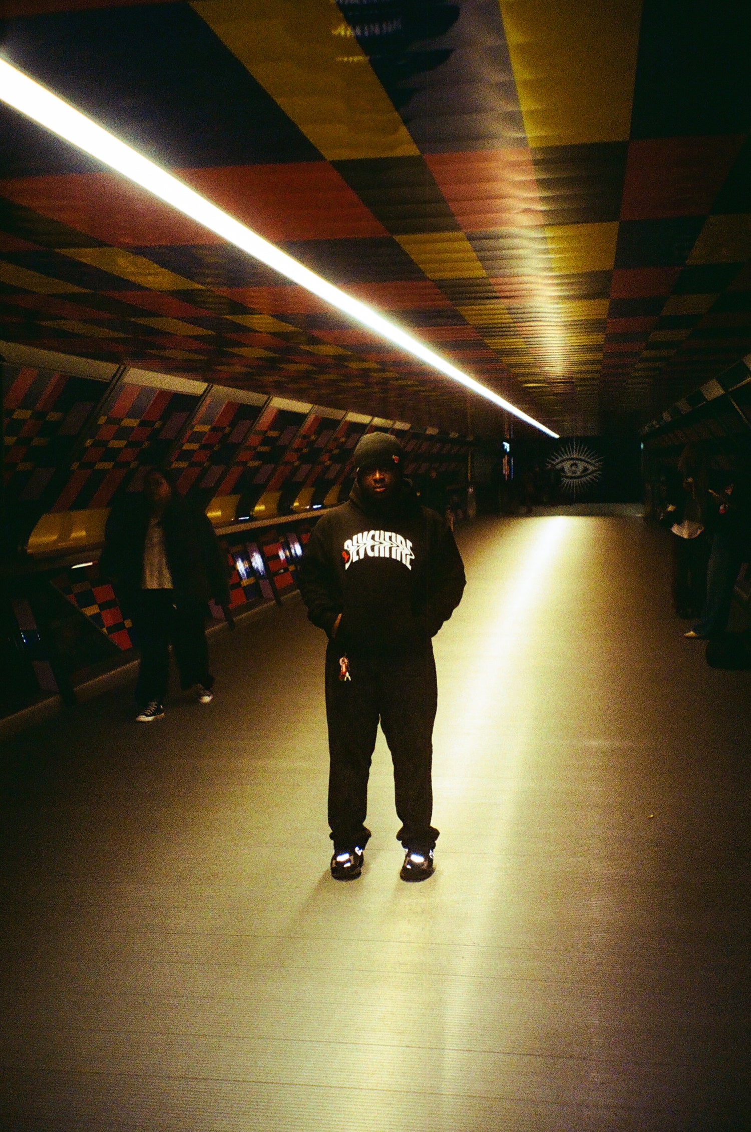 model wearing the bf warped hoodie standing in a walkway